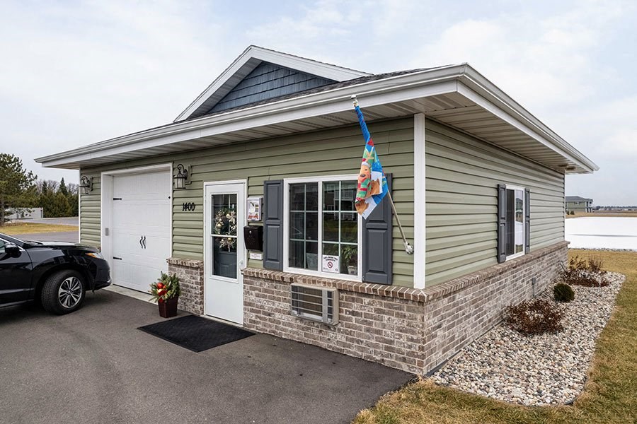 a small green house with a flag on the front of it