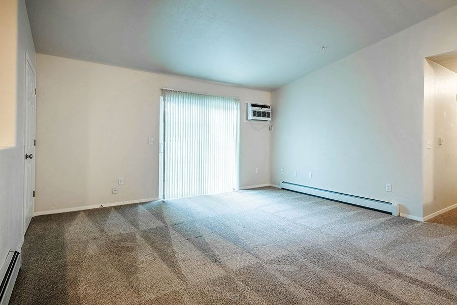 an empty living room with a sliding glass door