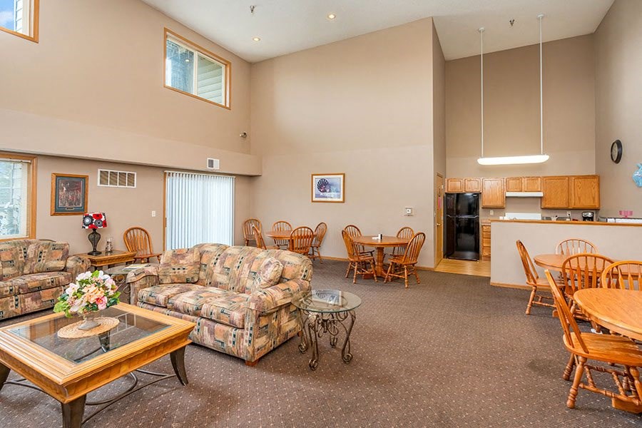 a living room with couches and chairs and a table