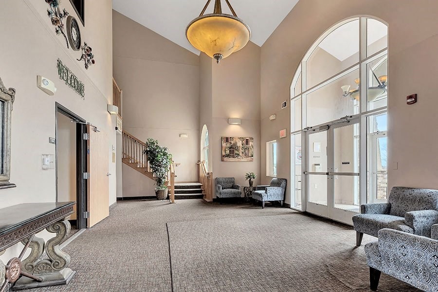 the lobby of a building with large glass doors