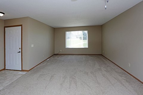 an empty room with a door and a window