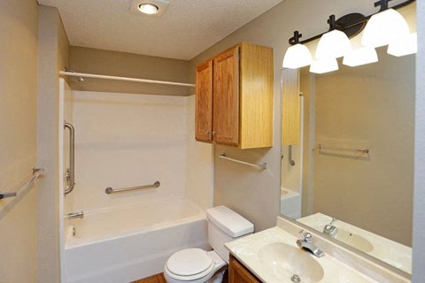 a bathroom with a sink toilet and a bath tub