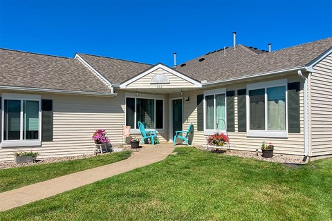 a house with a walkway and lawn in front of it
