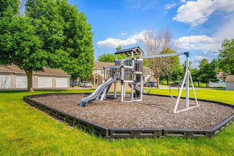 A playground with a slide and a swing set.