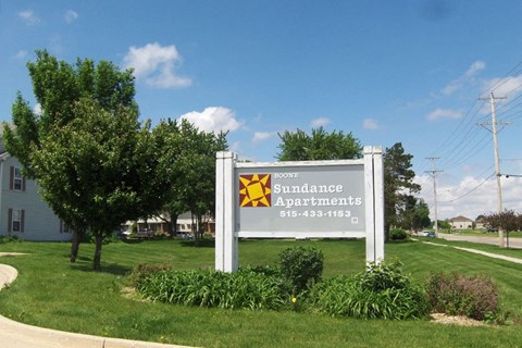 a sign for southeastern apartments in front of a grass field