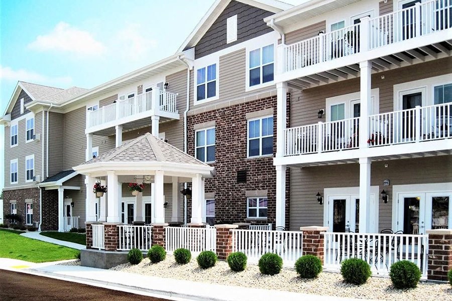 an apartment building with a porch and balconies