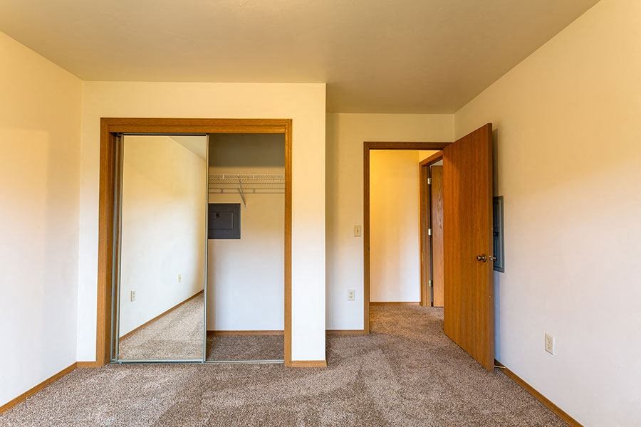 a empty room with three mirrors and a door