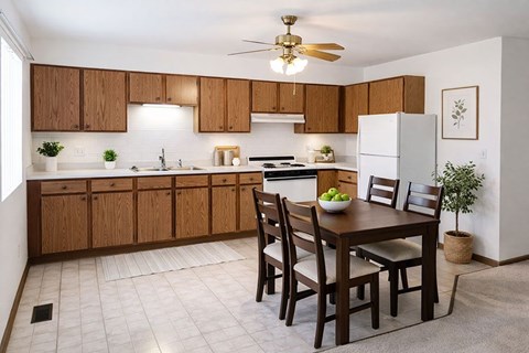 A kitchen with a table and chairs in the middle of the room.