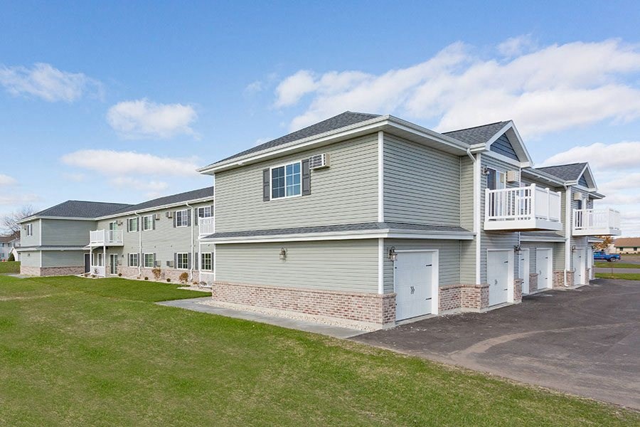a row of houses with balconies and a driveway