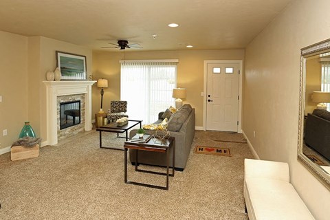 a living room with a couch and a fireplace