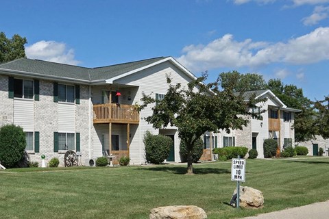 a white house with a yard and a street sign