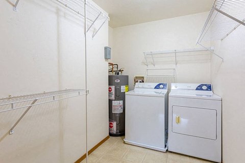 a laundry room with two washes and a refrigerator