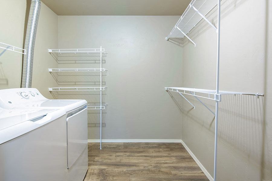 a laundry room with a sink and a mirrored closet