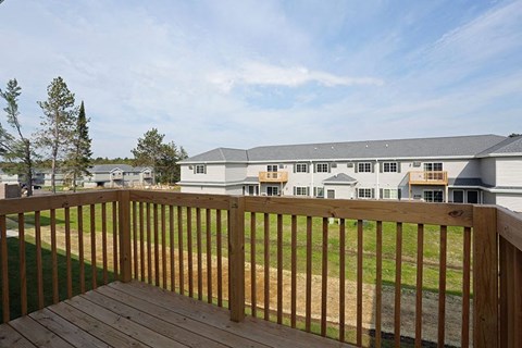 a backyard deck with a wooden fence
