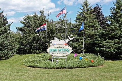 a sign for the springs golf course flags