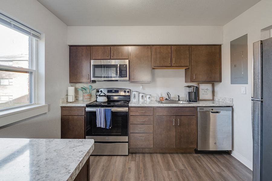 A kitchen with a stove top oven and a refrigerator.