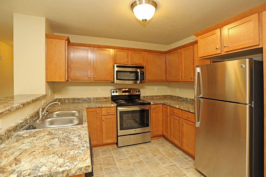 a kitchen with granite counter tops and stainless steel appliances