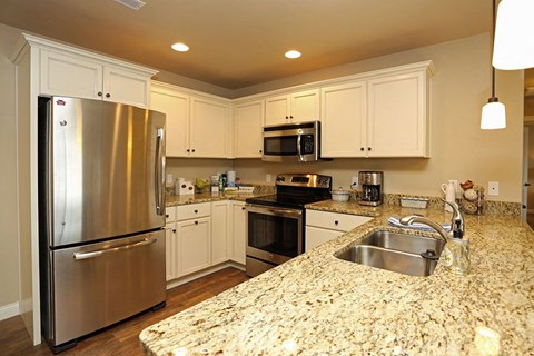a kitchen with granite counter tops and stainless steel appliances