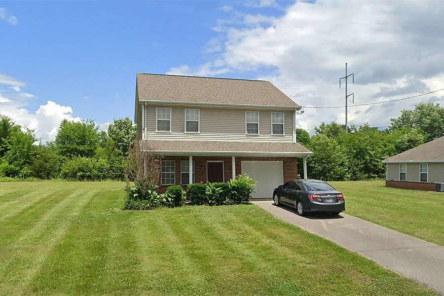 a house with a car parked in the driveway