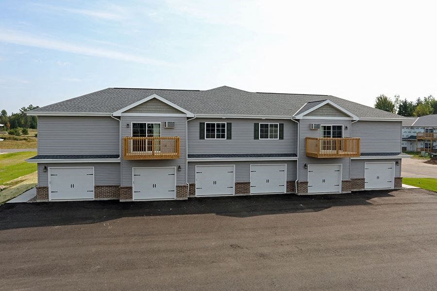 a house with a garage with white doors