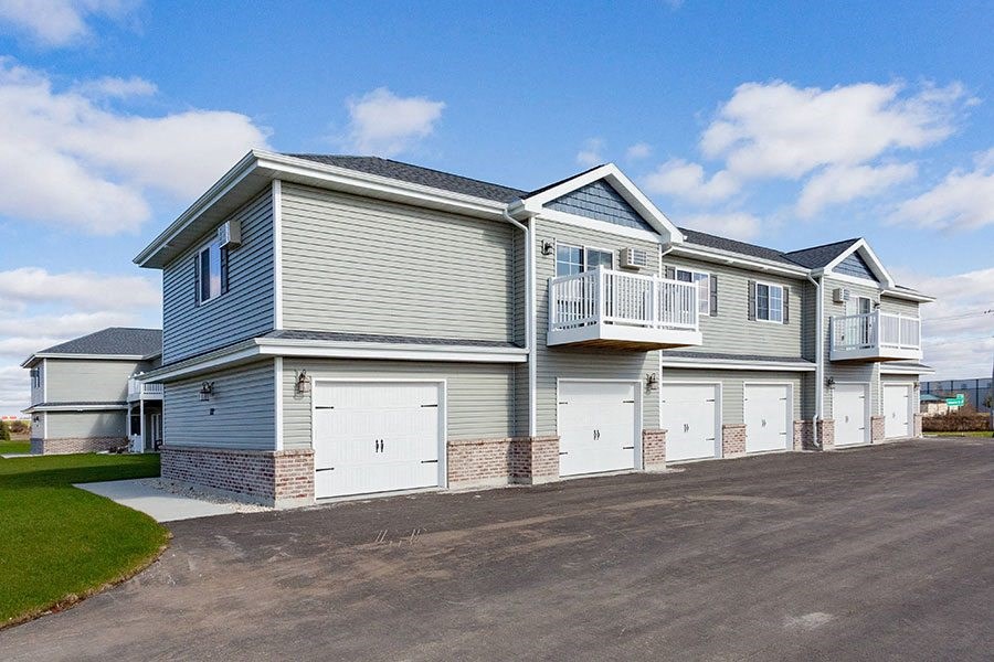 a blue and white house with white garage doors