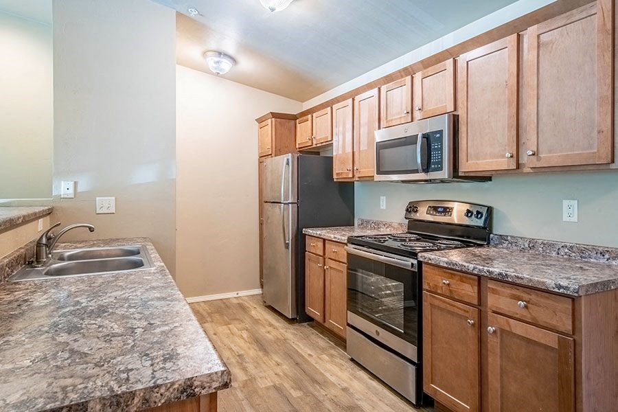 a kitchen with stainless steel appliances and granite counter tops