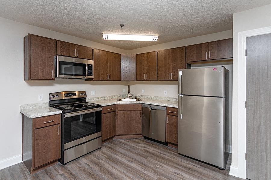 a kitchen with stainless steel appliances and wooden cabinets