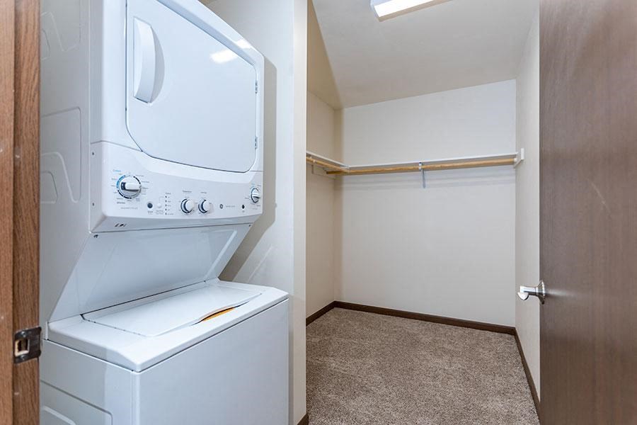 a bathroom with a washer and dryer and a closet