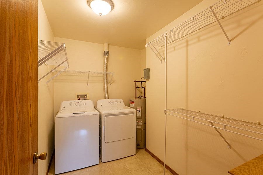 a laundry room with two washer and dryers in it