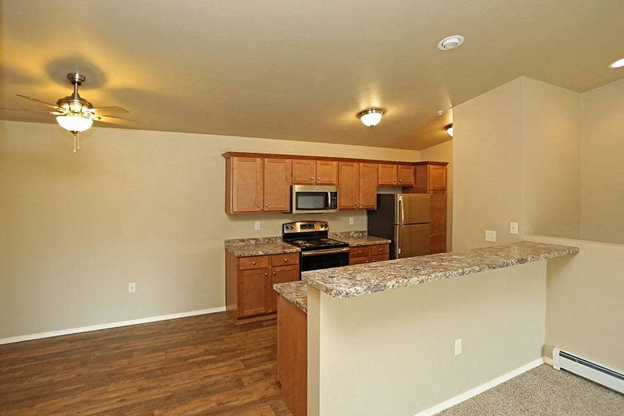 an empty kitchen with a granite counter top