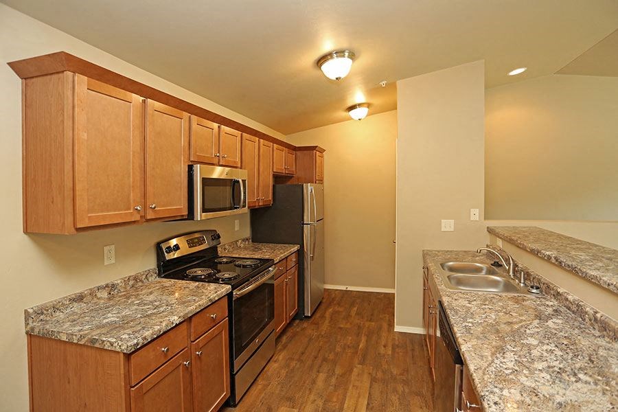 a kitchen with granite counter tops and stainless steel appliances