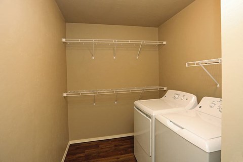 a laundry room with two washes and a dryer