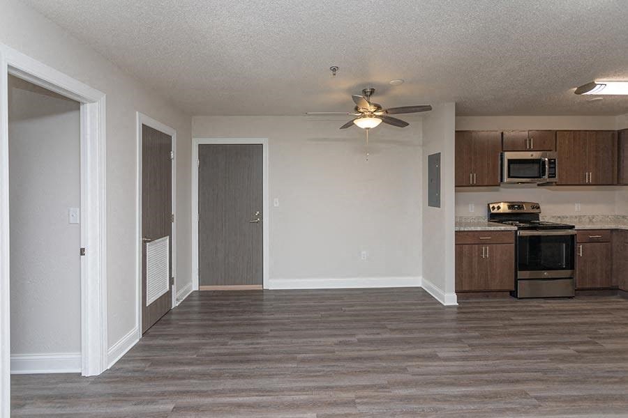an empty kitchen with a ceiling fan and