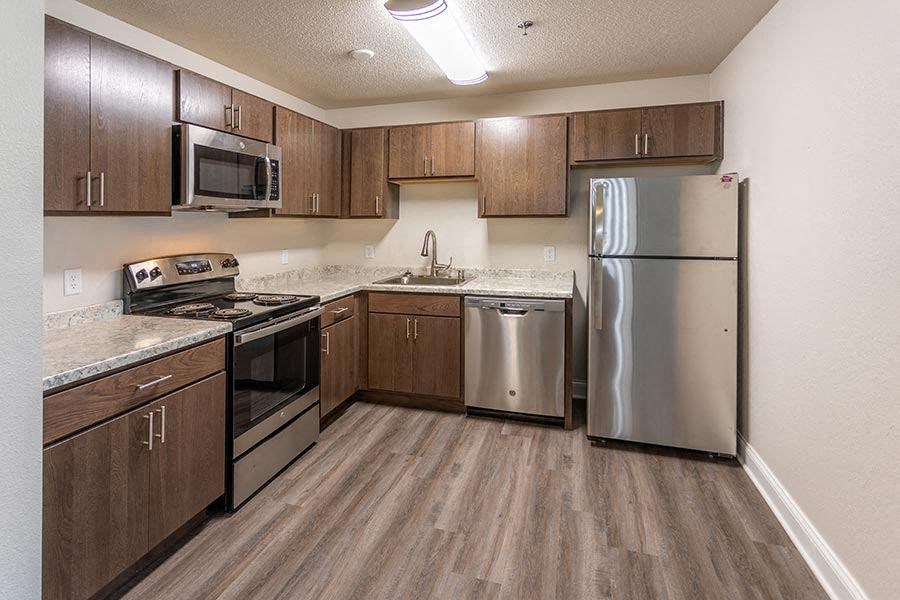 a kitchen with stainless steel appliances and wooden cabinets