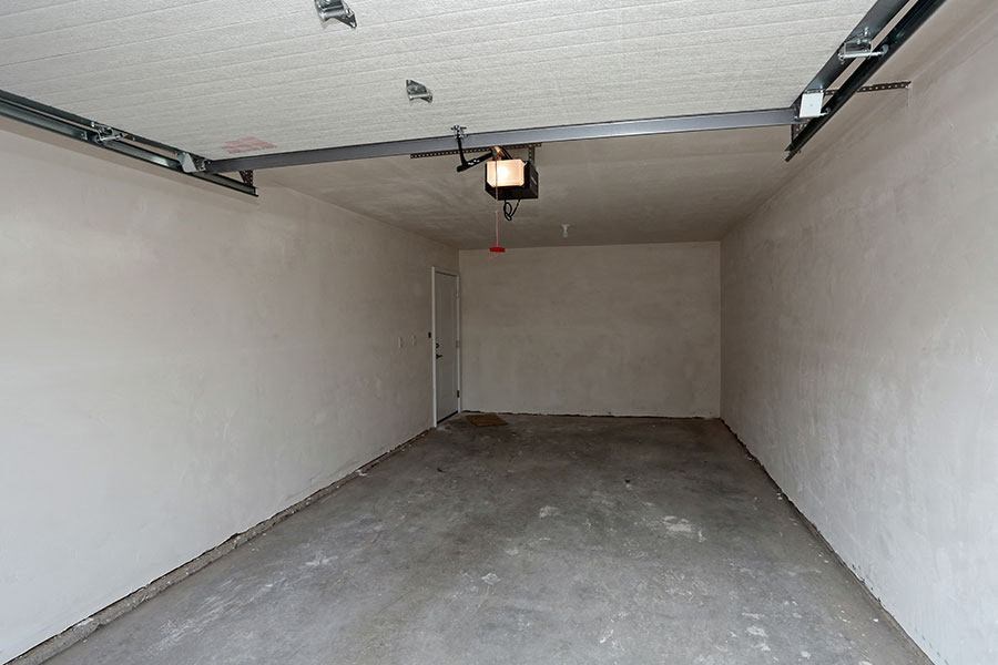 an empty garage with a light on the ceiling