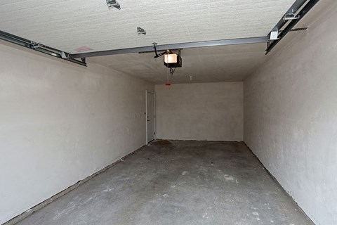 an empty garage with a light on the ceiling