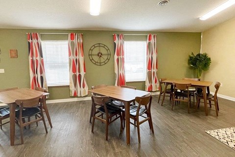 a dining room with tables and chairs