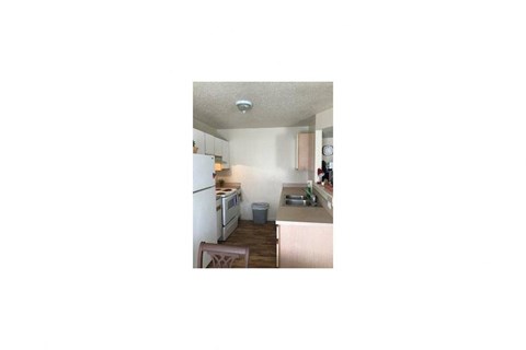 a small kitchen with a stove and a refrigerator