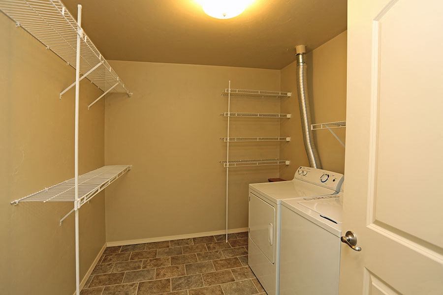 a small closet with a washer and dryer in it