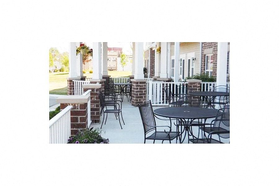 the patio of the building has tables and chairs