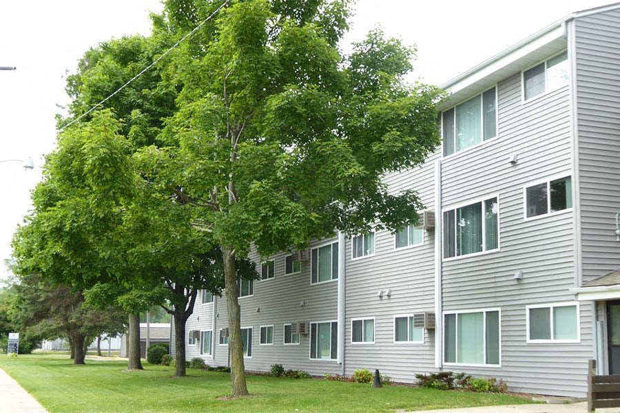 a large white building with trees in front of it