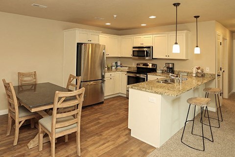 a kitchen with an island and a table with chairs