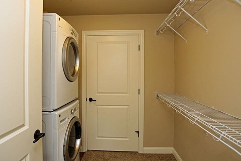 a laundry room with a washer and dryer and a closet