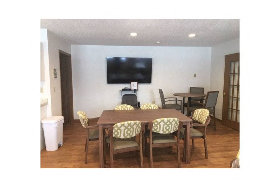 a dining room with a table and a television