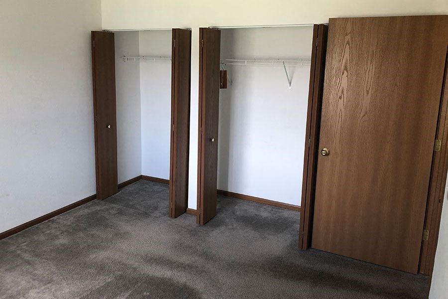 an empty room with three doors in it