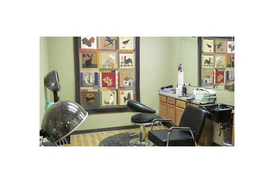 a hair salon with a chair and a desk