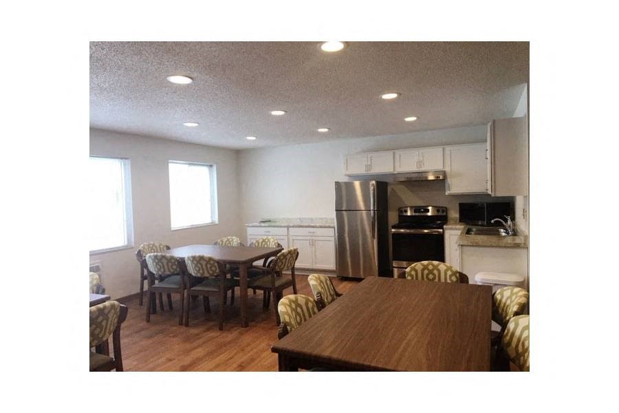 a kitchen and dining room with a table and chairs