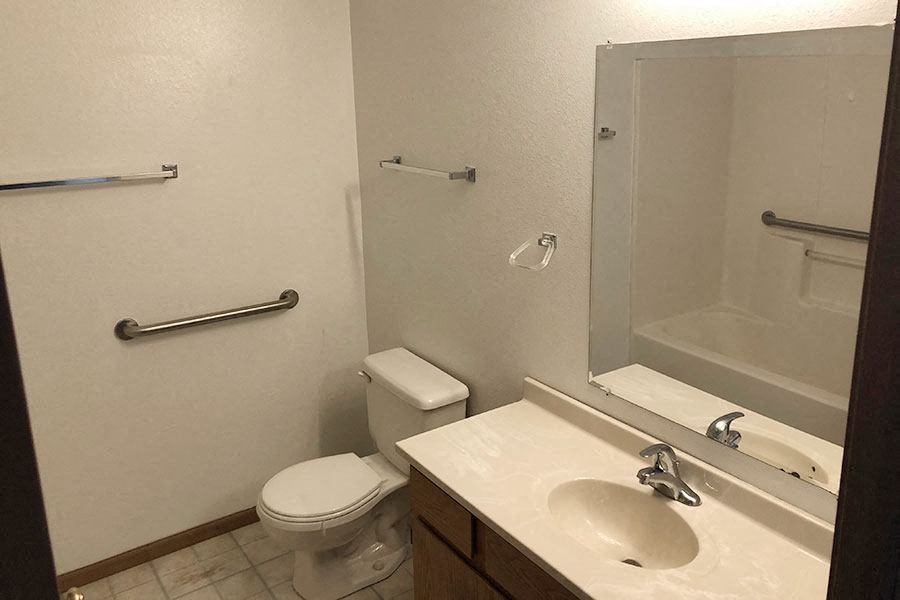 a bathroom with a sink toilet and a mirror