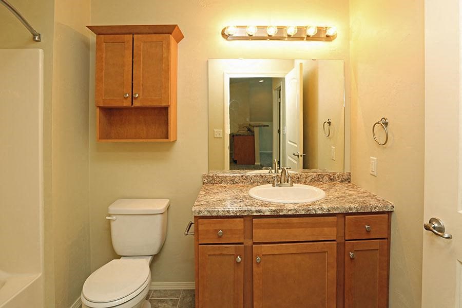 a bathroom with a sink toilet and a mirror