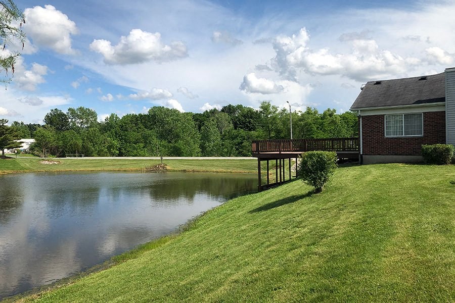 a house sitting next to a lake with a dock